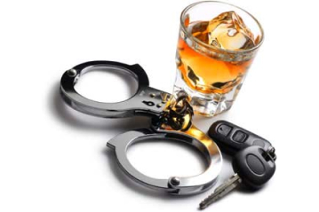 A cocktail alongside handcuffs and car keys